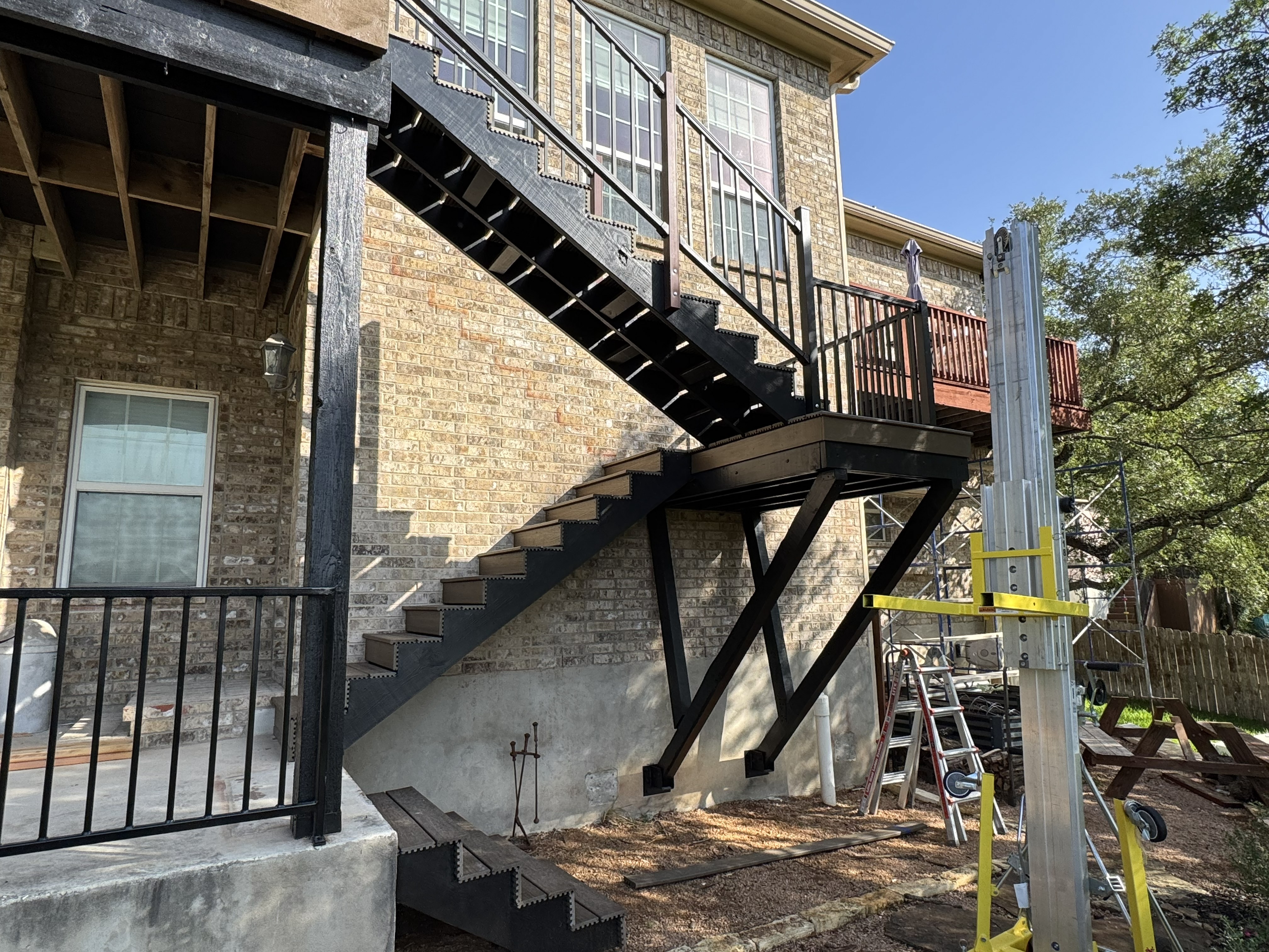 Two-story composite deck and exterior straircase rebuilt by Industrious Duo