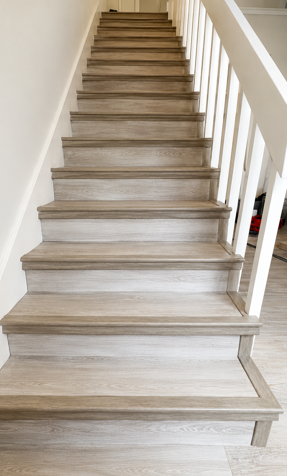 Continuous flooring installation with custom stair-nose detailing